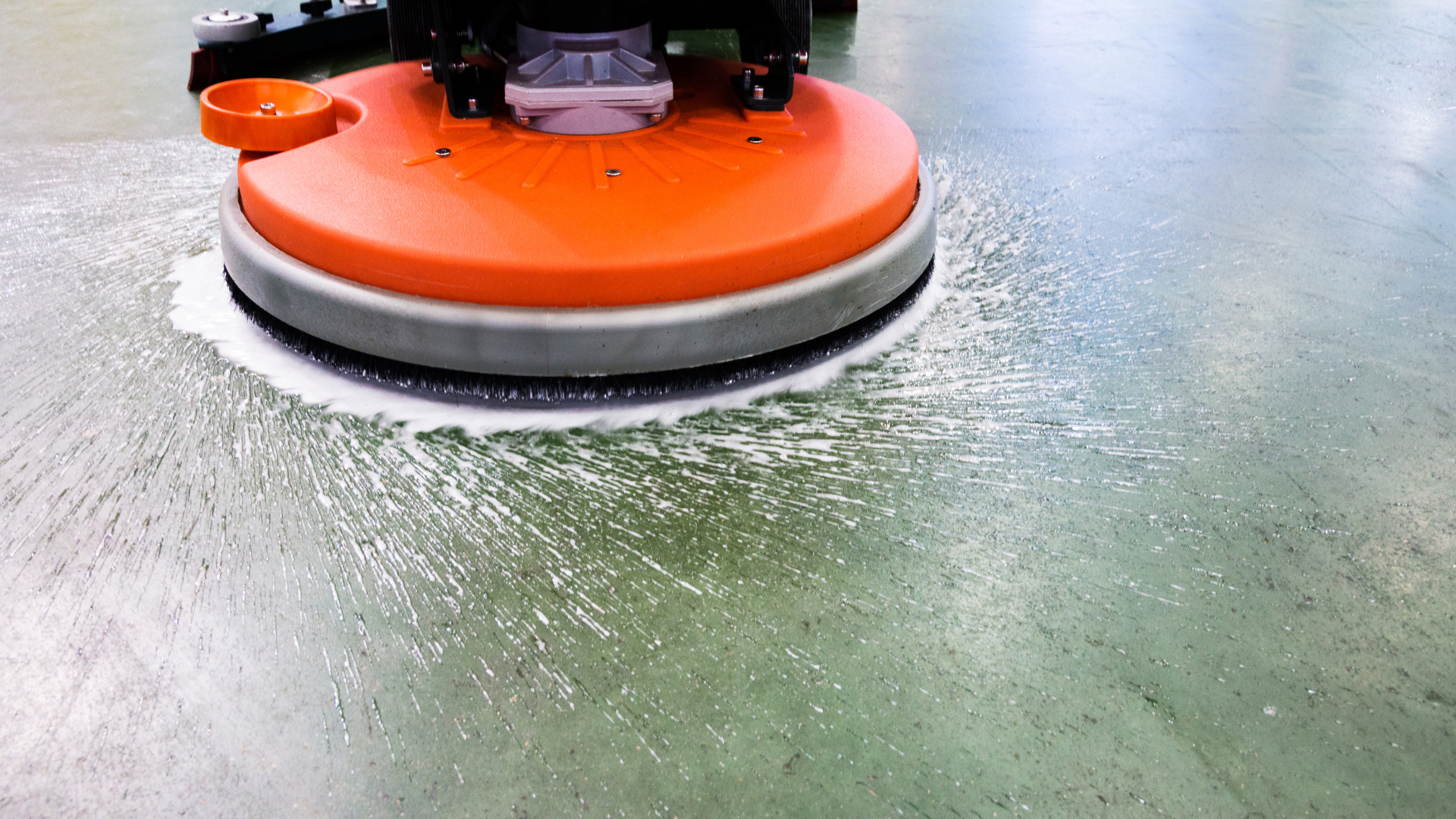 A floor cleaning machine on top of a wet floor